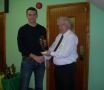 Michael Corrigan receives his award from Moss Doody on entry to the '200' club.