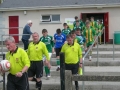 The Teams and officials enter the pitch.